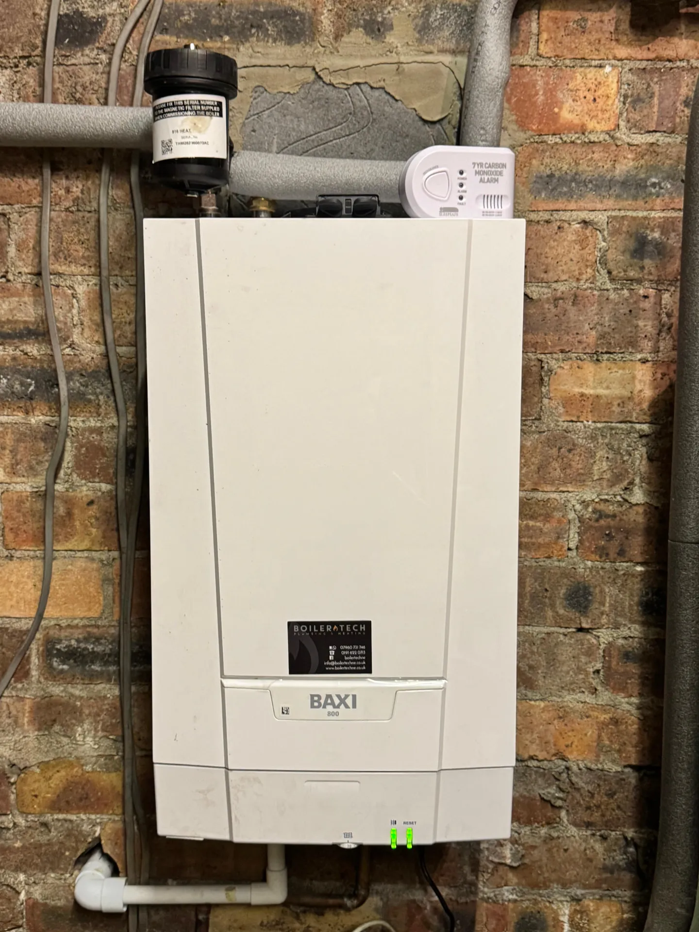 Baxi 800 boiler installed on a brick wall with magnetic filter and carbon monoxide alarm